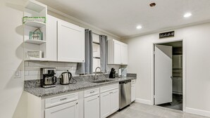 A modern kitchen with white cabinets, granite countertops, and stainless steel appliances. - Pet-friendly Home w/ Lanais, Near Dtwn Tampa! (Seffner)