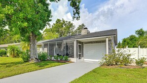 A modern house with a garage, a covered porch, and a well-maintained lawn. - Pet-friendly Home w/ Lanais, Near Dtwn Tampa! (Seffner)