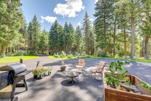 A patio with outdoor furniture, a grill, and a garden bed. - 'crystal Lake Retreat' Studio w/ Outdoor Space! (Libby)