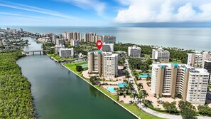 A high-rise hotel with a pool and a view of the ocean. - Vanderbilt Beach Views from 2 Lanais (Naples)