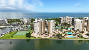 A high-rise hotel with multiple floors, a marina, and a tennis court.