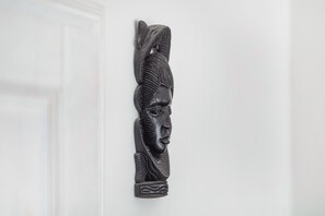 A wall-mounted sculpture of a human figure.