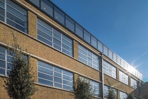 A multi-story building with large windows and a brick facade.