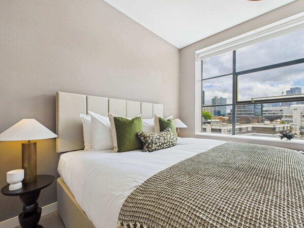 2 habitaciones, escritorio y tabla de planchar con plancha
