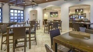 A restaurant with high ceilings, exposed beams, and a bar area. - Magical Getaway Near Disney Private Pool + Resort Access, Bbq Grill! 4 Bedroom Townhouse (Kissimmee)