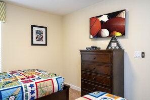 A bedroom with a bed, a dresser, a television, and a framed picture on the wall. - Family Pool Home Near Disney!! Modern Decor, Bbq ,resort W/ Tons Of Amenities! 6 Bedroom Home (Kissimmee)