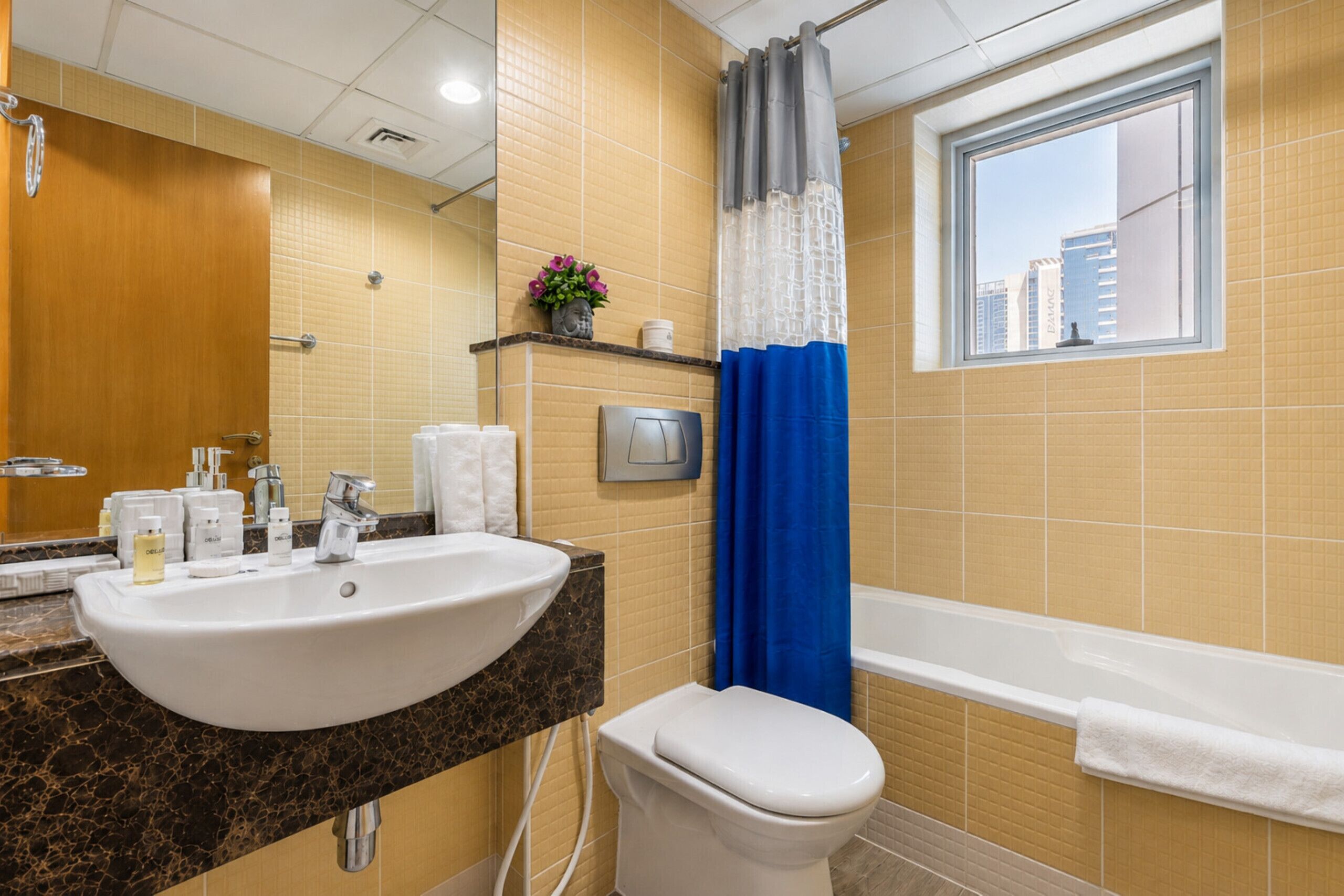 A bathroom with a sink, toilet, and bathtub.