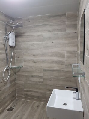 Shower, hair dryer, towels, toilet paper