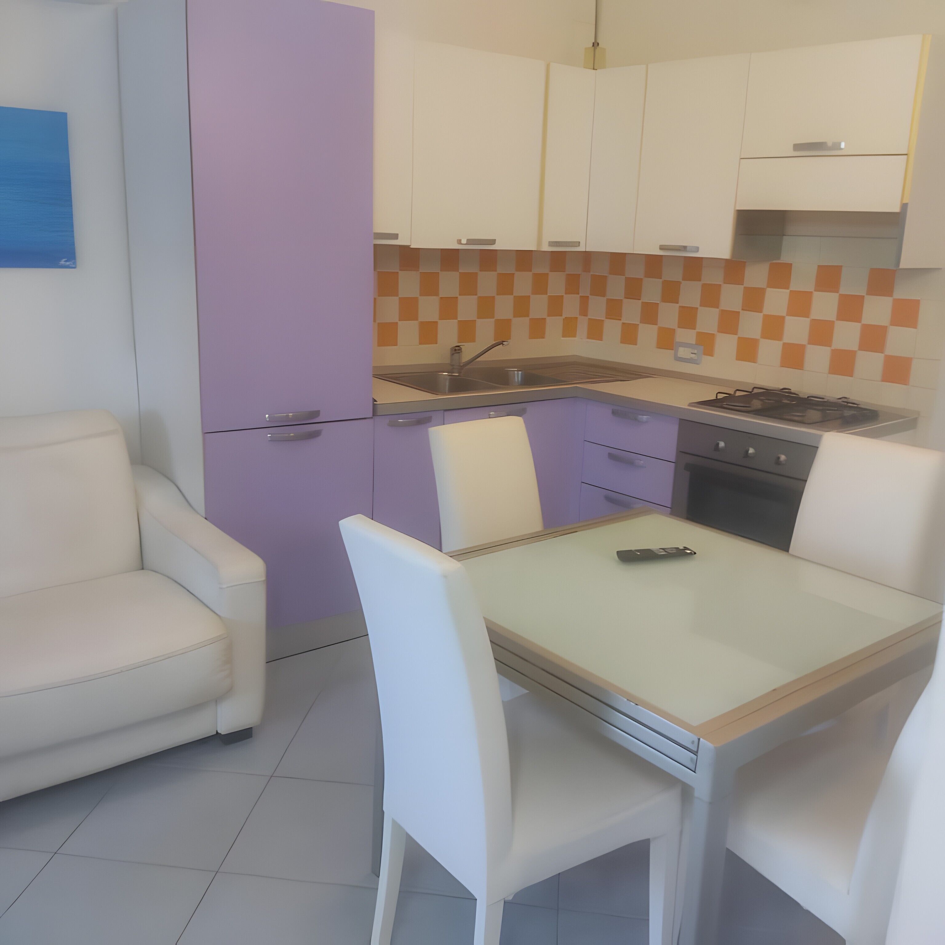 A modern kitchen with white cabinets, a purple refrigerator, and a tiled backsplash.