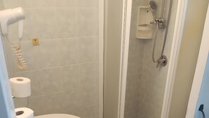 A bathroom with a sink, toilet, and shower.
