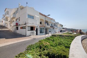 A coastal building with a no entry sign, a visible entrance, and a paved walkway.