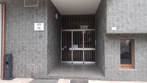 A building entrance with a metal gate, a sign with 'BB' and a logo, and a small window on the right. - B&B Stern (Porto San Giorgio)