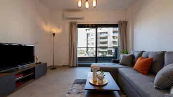 Apartment | Living area | 65-cm Smart TV with satellite channels