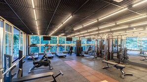 A modern gym with treadmills, weight machines, and exercise mats. - Stay in a Building With a Pool, Gym, and Leisure - SSL (Florianópolis)