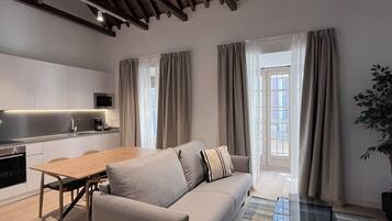 Apartment, 2 Bedrooms | Living area | 28-inch flat-screen TV with cable channels