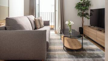 Apartment, 1 Bedroom | Living area | 28-inch flat-screen TV with cable channels