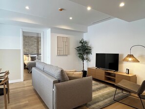 Apartment, 1 Bedroom | Living area | 28-inch flat-screen TV with cable channels