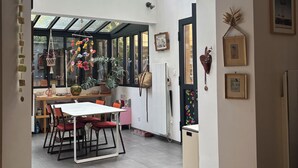 A modern kitchen with a dining area, large windows, and a skylight.