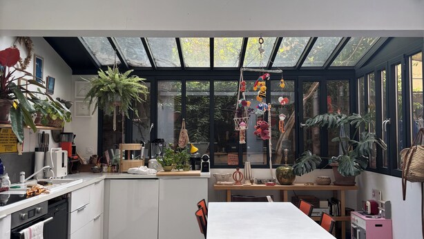A modern kitchen with a large island, ample counter space, and a dining area with a table and chairs.