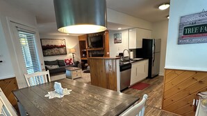 A modern kitchen with a central island, wooden cabinets, and a built-in oven. - Charming 2-bedroom Stratton Mountain Condo with shuttle service (Stratton)
