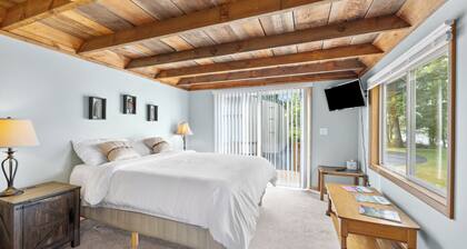 Scenic riverfront cottage with boat landing and docks.
