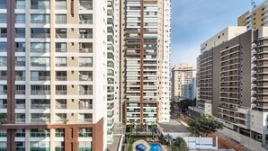 A high-rise residential building with multiple balconies, a swimming pool, and a well-maintained garden area. - Vision0707 in S o Paulo (São Paulo)