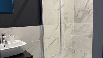 Shower, towels, soap, toilet paper