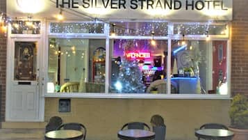 Hotel Silver Strand con un árbol de Navidad y un letrero de neón.