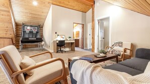 A cozy living room with a basketball hoop, a desk, and comfortable seating. - Lodge at Summit Park Near Woodward (Park City)