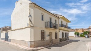 A two-story building with a balcony, a door, and a window. - Casa Mercedes for Large Families. Air Conditioning (Valderrubio)