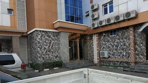 A building with a stone facade, multiple air conditioning units, and a gated entrance. - Milton Park Resorts (Kano)