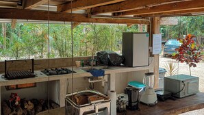 A rustic kitchen with a wooden ceiling, a sink, a stove, and various appliances. - Hotel Xu-La Azul (Xul-Ha)