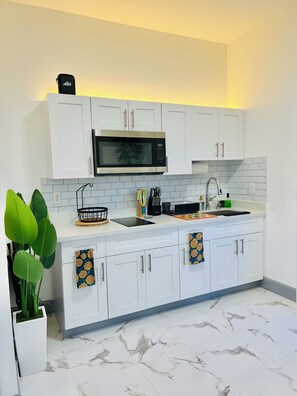 Fridge, microwave, stovetop, coffee/tea maker