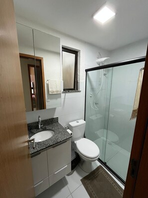 Shower, hair dryer, towels, toilet paper