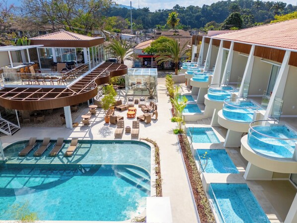 A resort with multiple swimming pools, lounge areas, and a view of the surrounding landscape. - Sdesign Paraty Hotel (Paraty)