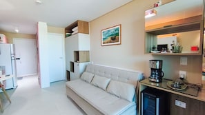 A modern living room with a sofa, a coffee machine, and a refrigerator. - Beach Class Summer Residence (Ipojuca)