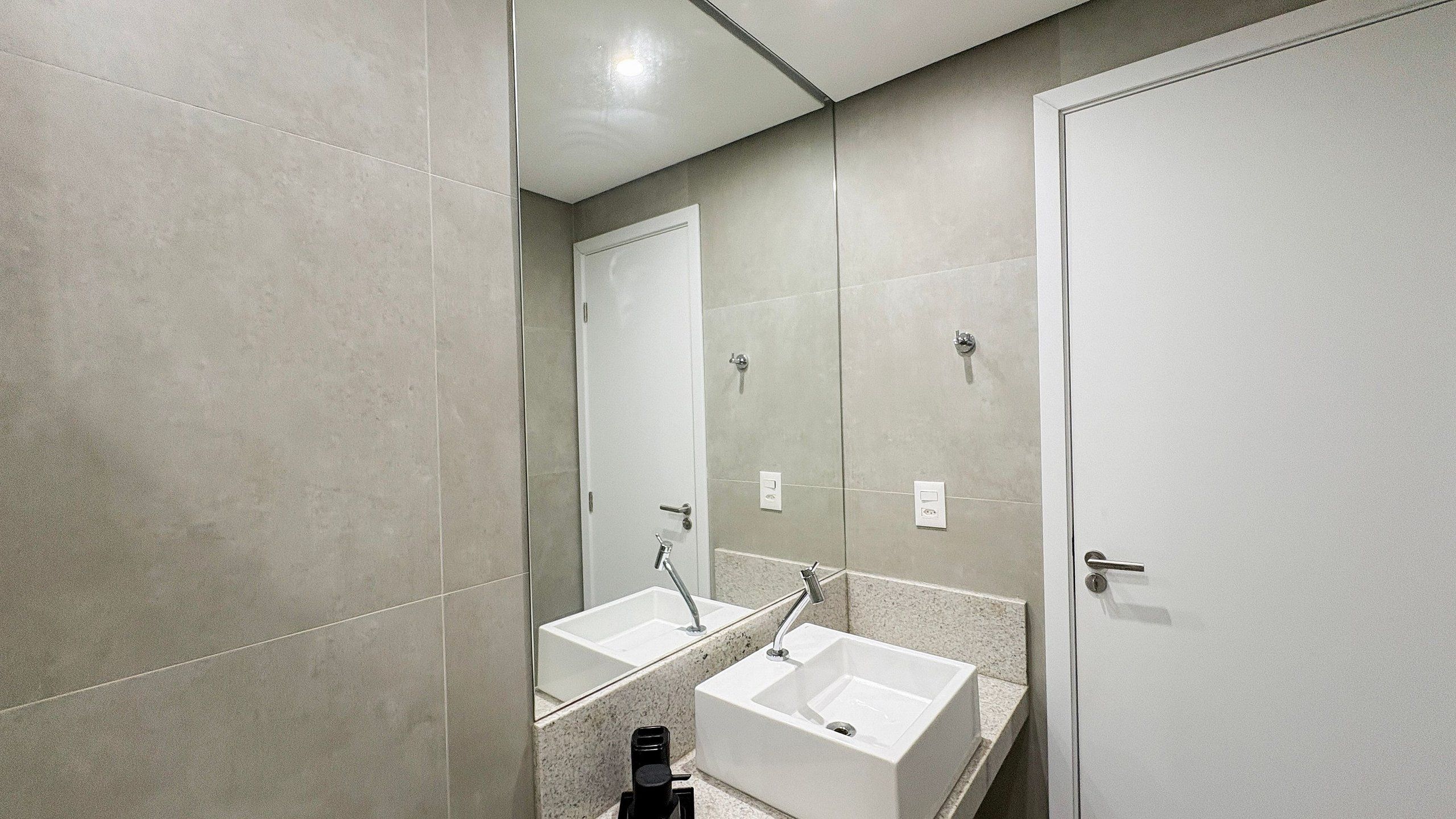 Une salle de bain avec deux lavabos, un miroir et une douche.