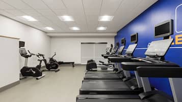 A fitness center with treadmills, stationary bikes, and weight machines.