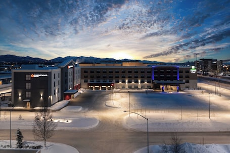 A hotel with a parking lot, a building with a 'Candlewood' sign, and a 'Hampton Inn Express' sign.