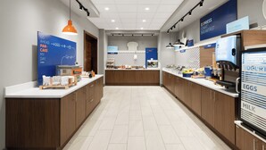 A modern kitchen with wooden cabinets, a central island, and a refrigerator displaying yogurt, eggs, and milk. - Holiday Inn Express And Suites Anchorage Midtown by IHG (Anchorage)