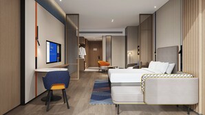 A modern hotel room with a bed, a desk, a chair, and a television. - Holiday Inn Express Quanzhou Fuqiao by IHG (Quanzhou)