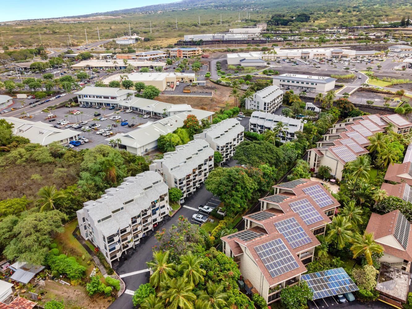 A residential area with multiple apartment buildings, roads, and greenery.