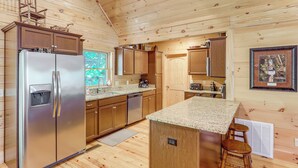 A wooden cabin kitchen with a refrigerator, dishwasher, and wooden cabinets. - Updated Cabin By Linville Falls: Deck & Game Room! (Marion)