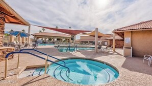 A pool area with multiple swimming pools, lounge chairs, and shaded areas. - Leisure World Oasis. Charming 2-bedroom townhome. 24 Hours security in Mesa (Mesa)