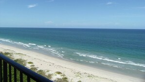 A beach with a clear view of the ocean and a sandy shoreline.