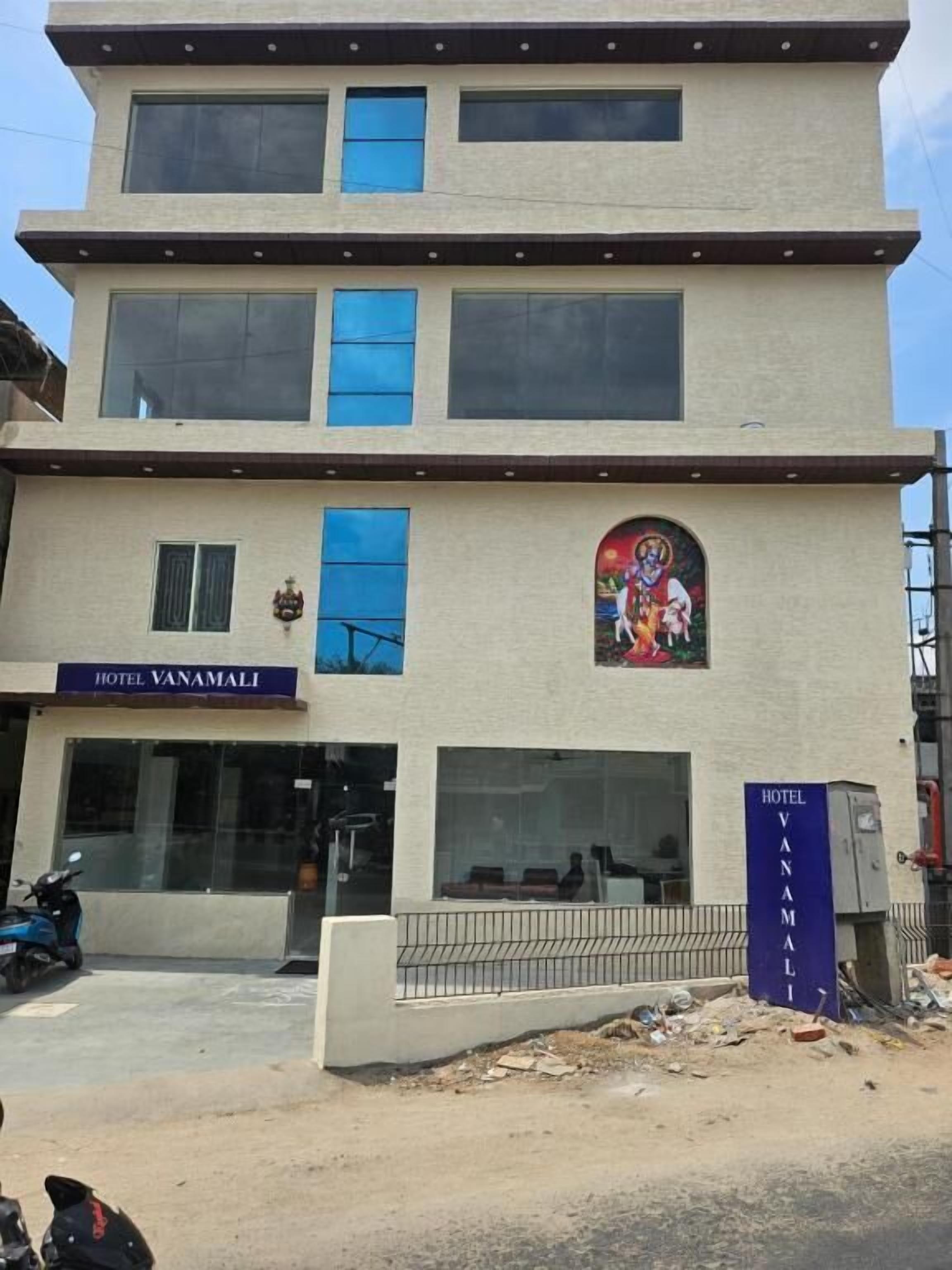 A multi-story building with a sign for Hotel Vanamali.