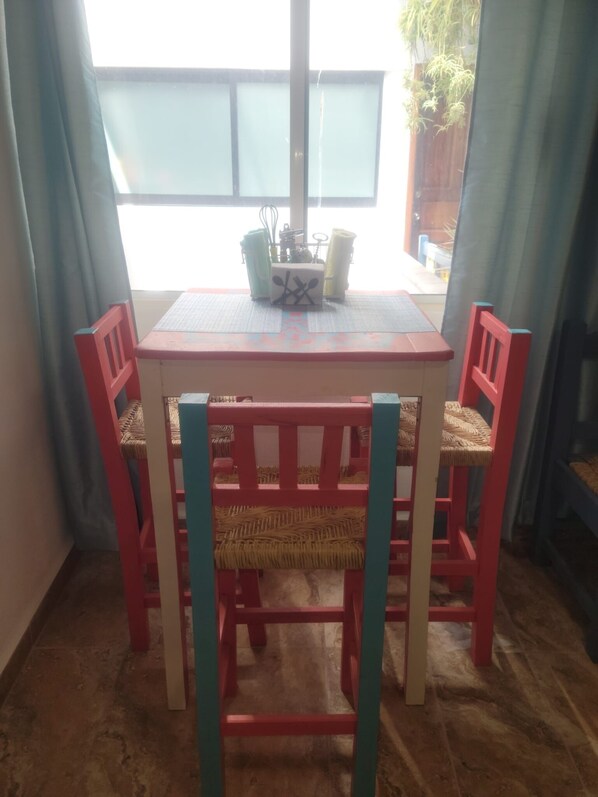A dining area with a table and four chairs.