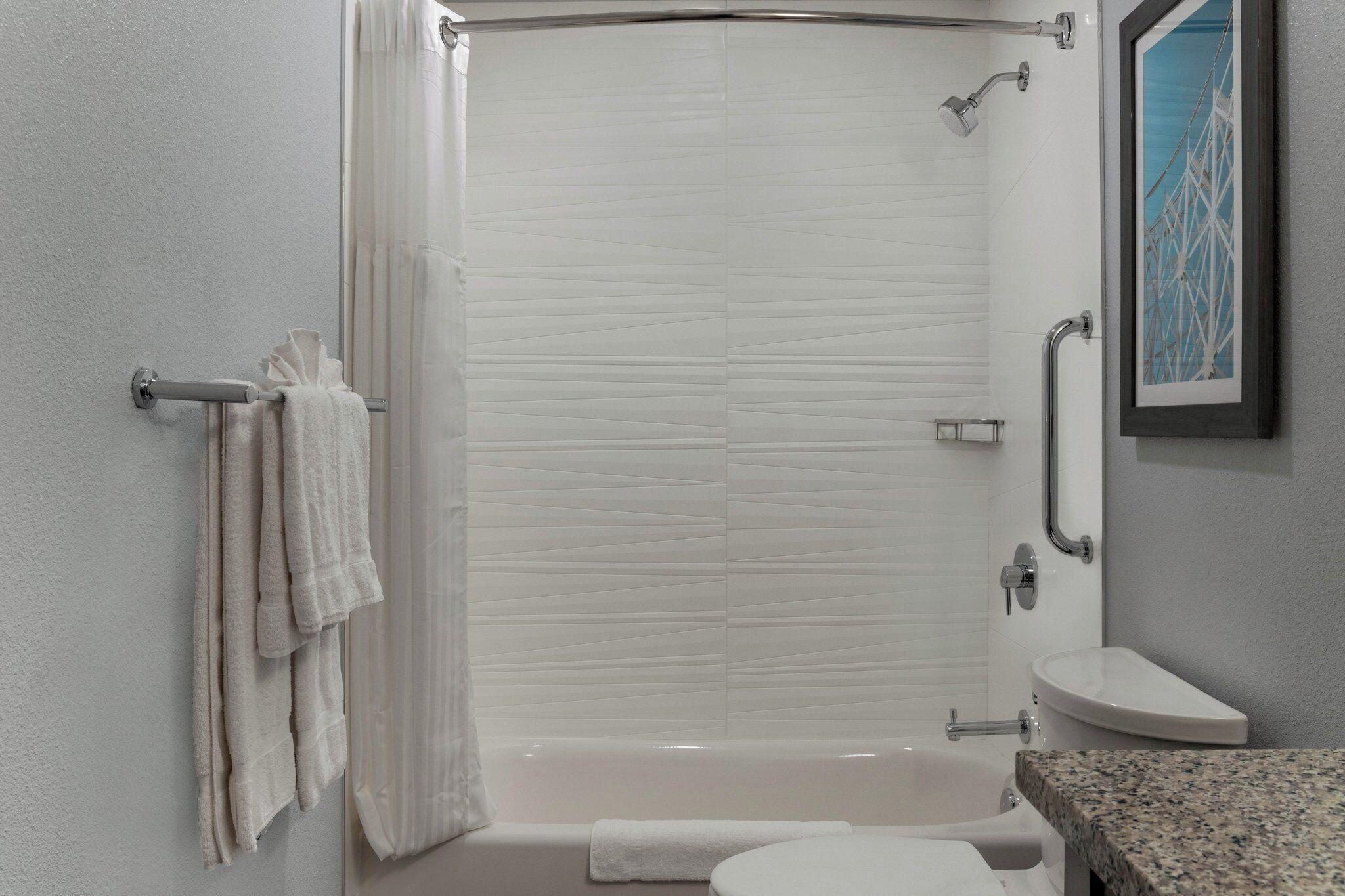A bathroom with a bathtub, toilet, and sink.