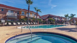 A swimming pool area with lounge chairs and a poolside deck. - Quiet Resort 3BR Nature Walk 20min to Disney (Kissimmee)