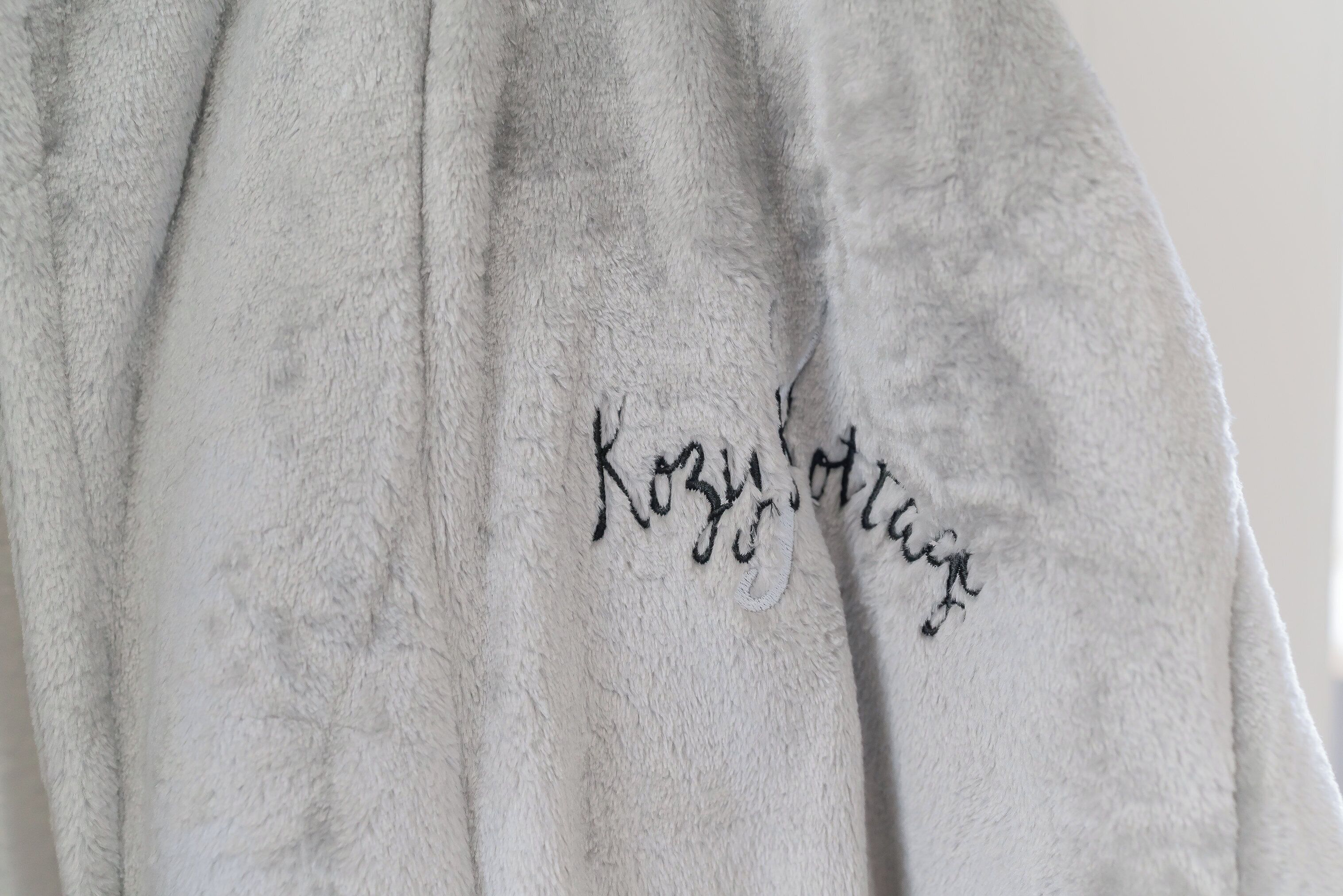 A white towel with embroidered text.